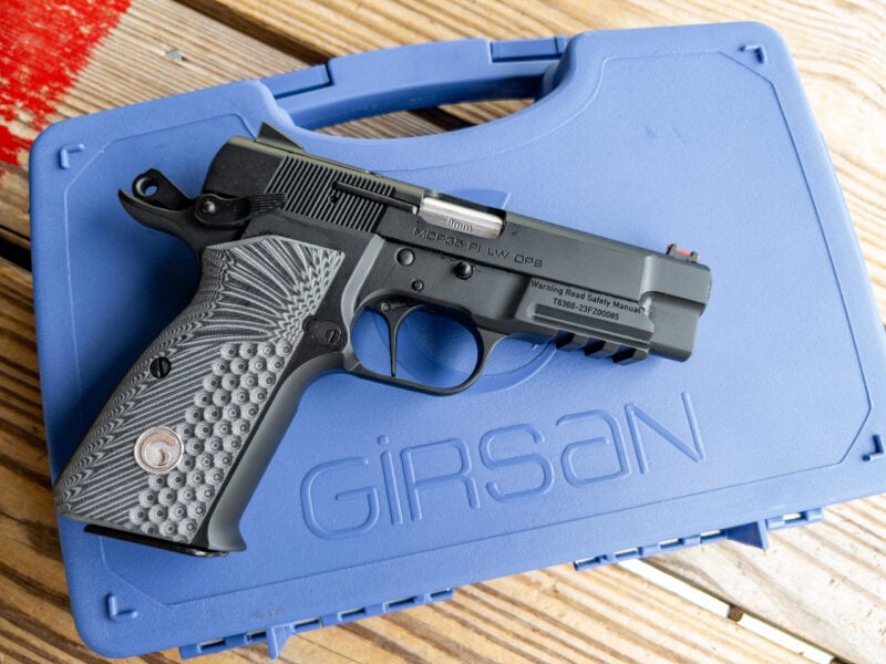 The Girsan MCP35 LW OPS handgun sitting atop its blue hardshell case.