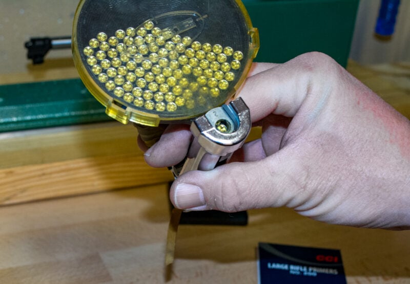 Most hand priming tools, like this Lee model, use a tray that gravity feeds primers into position for the next case. Hold at an angle like this, and the next one drops into place.